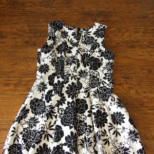 White and black floral dress worn once.  V neck in front zips up in back